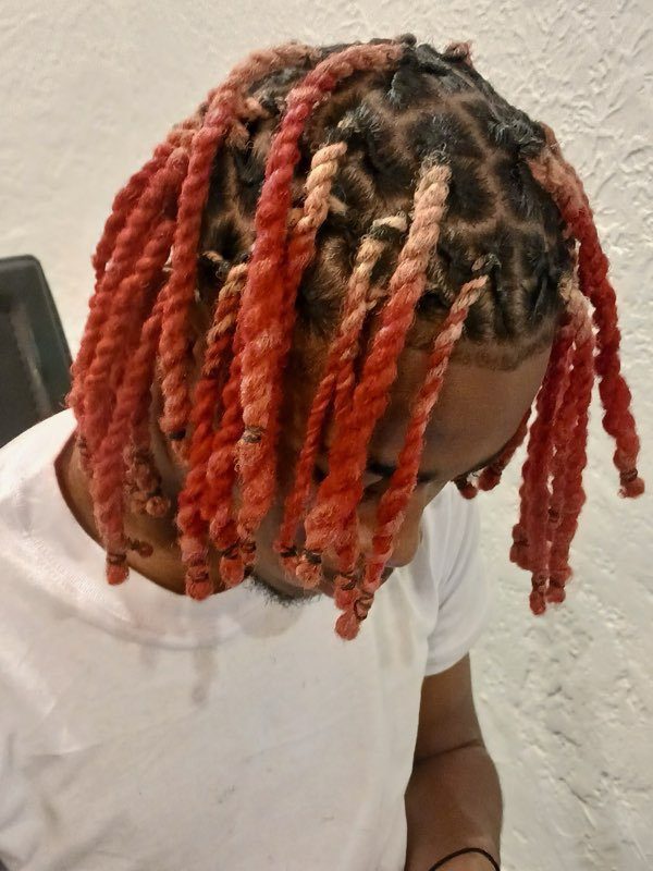 Red colored locs styled by Keturah